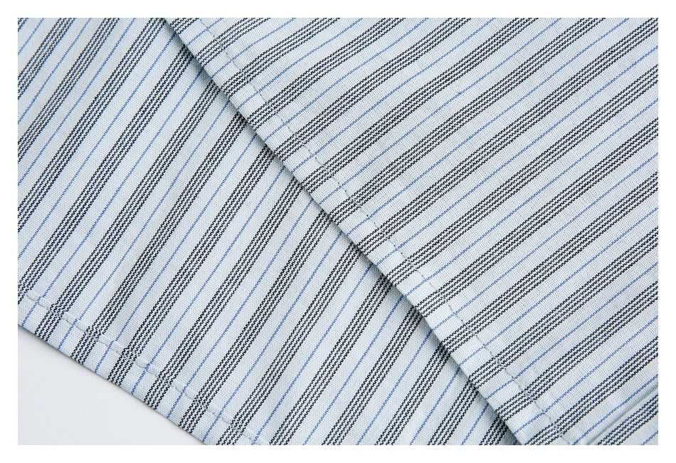 Close-up of overlapping striped fabric panels with visible stitching.