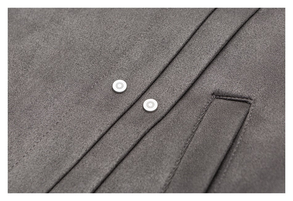 Close-up of the gray jacket’s silver snaps and narrow welt pocket.