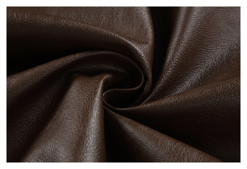 Close-up of dark brown pebbled material twisted into folds.