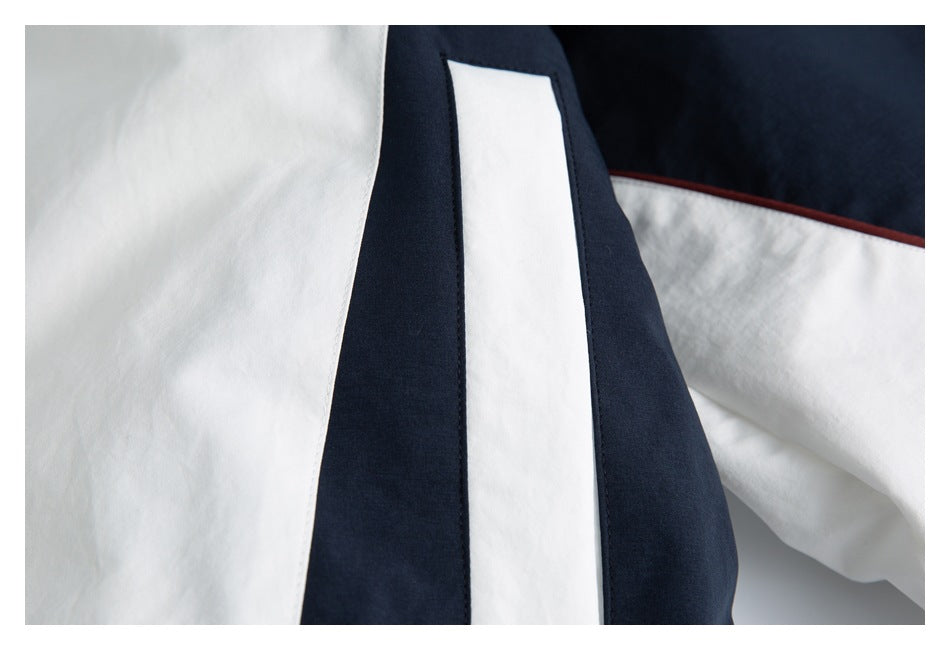 Close-up of a white vertical panel bordered by navy fabric, with white and burgundy sections nearby.