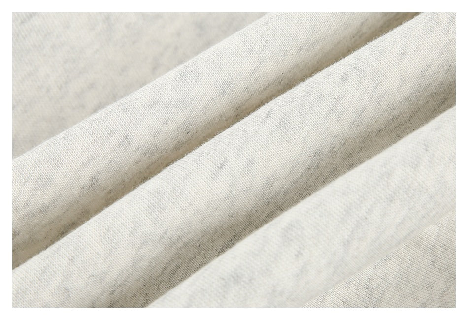 Close-up of the light heather-gray garment fabric, showing its soft-looking knit texture.