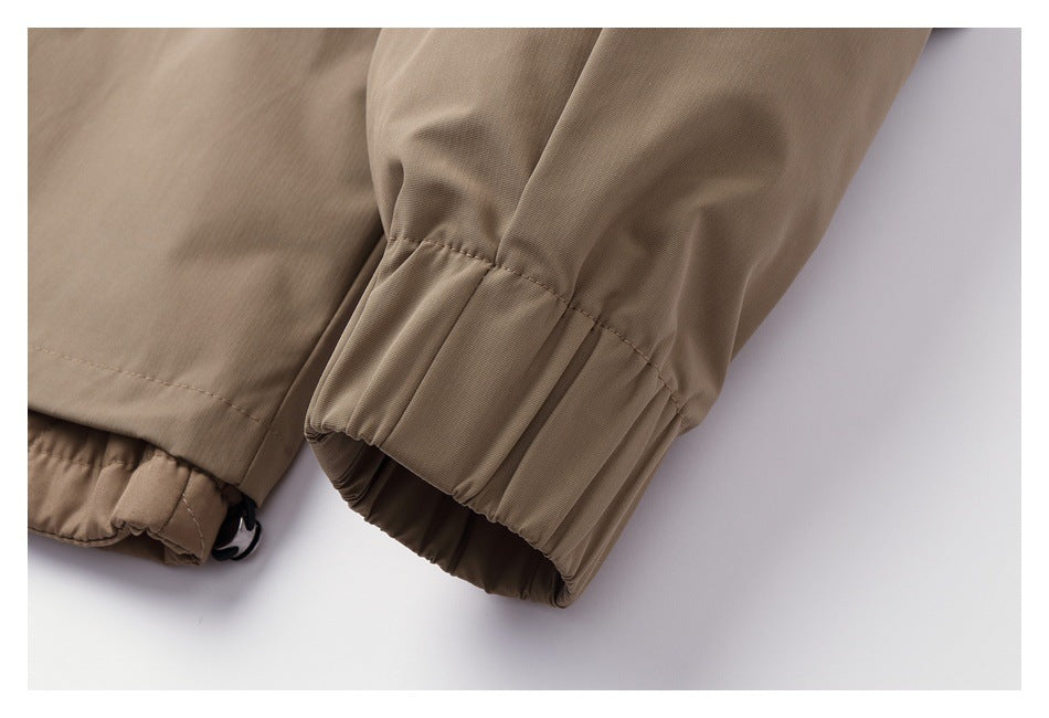 Close-up of a beige garment sleeve ending in a gathered cuff.