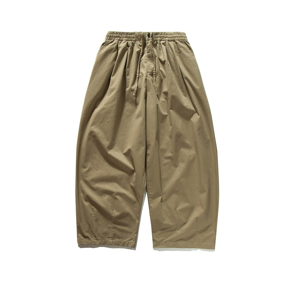 Khaki wide-leg pants with elastic drawstring waist, button closure and front pleats, flat lay front view