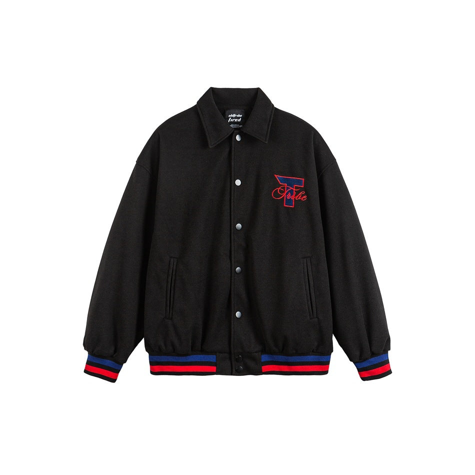 Black varsity-style jacket, front view, with snap buttons, striped blue and red ribbed trim and embroidered T logo