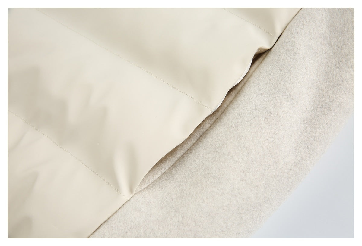 Close-up of cream jacket lining and a pale beige textured outer panel with visible stitching.