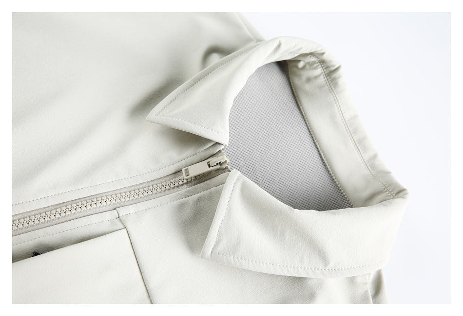 Close-up of the off-white jacket's collar, inner mesh panel and front zipper.