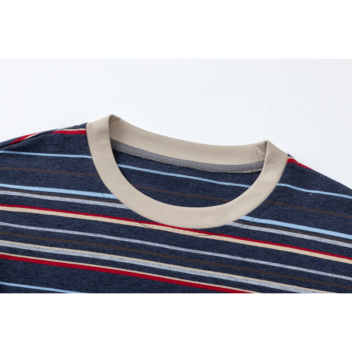 Close-up of a navy striped shirt with a beige ribbed crew neckline.