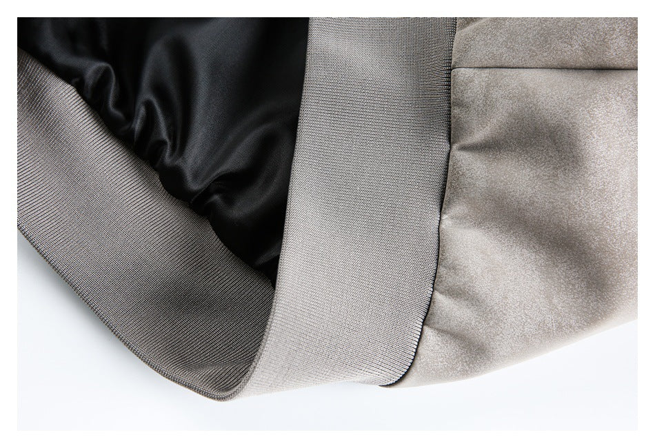 Close-up showing the light gray jacket's ribbed hem and smooth black lining.