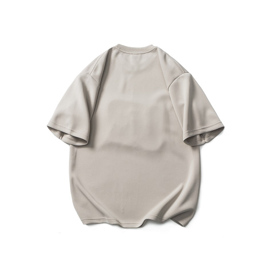 Back view of a plain light khaki short-sleeve T-shirt with ribbed crew collar and drop shoulders