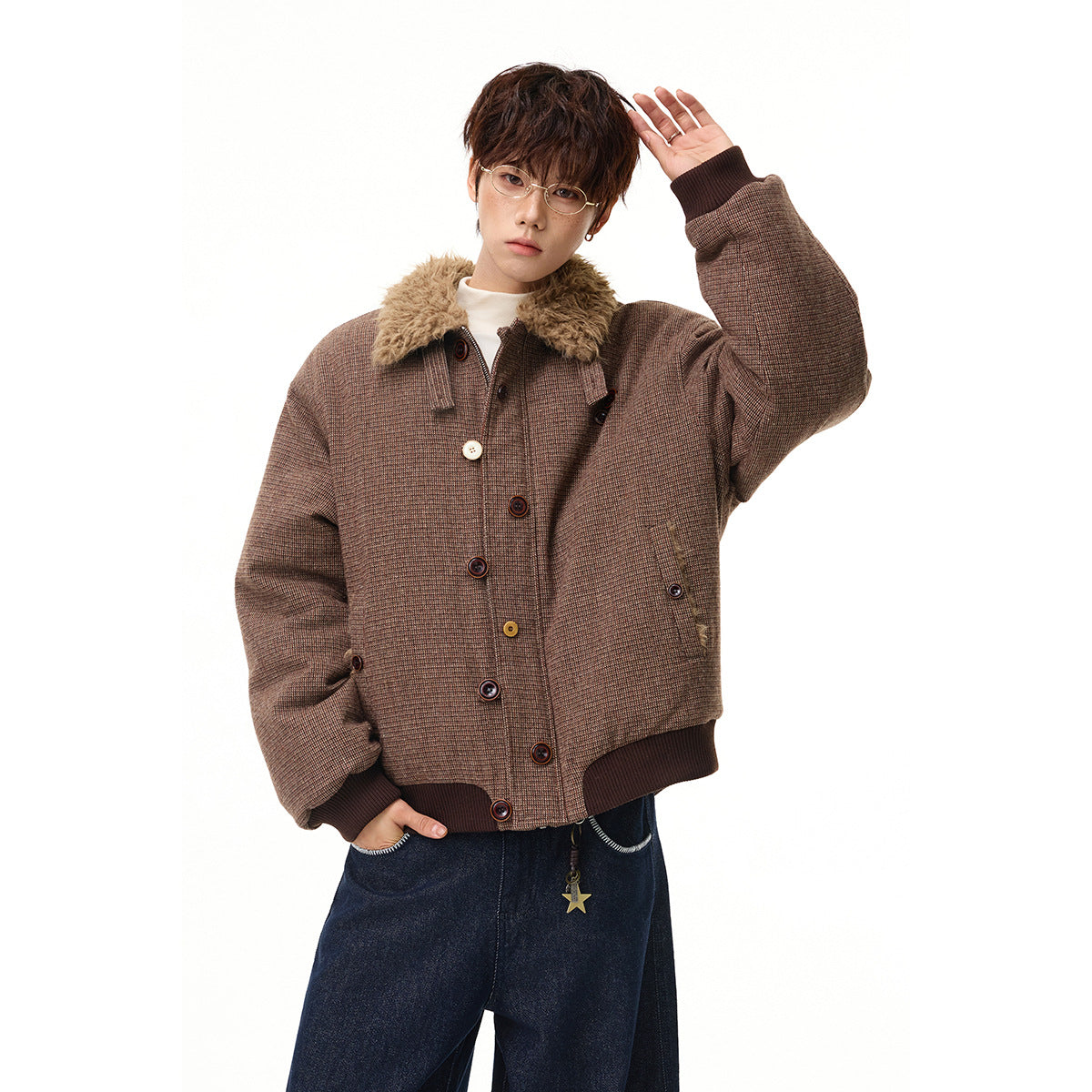 Model wearing a brown micro-check jacket with a plush tan collar, dark ribbed cuffs and hem, and assorted buttons.