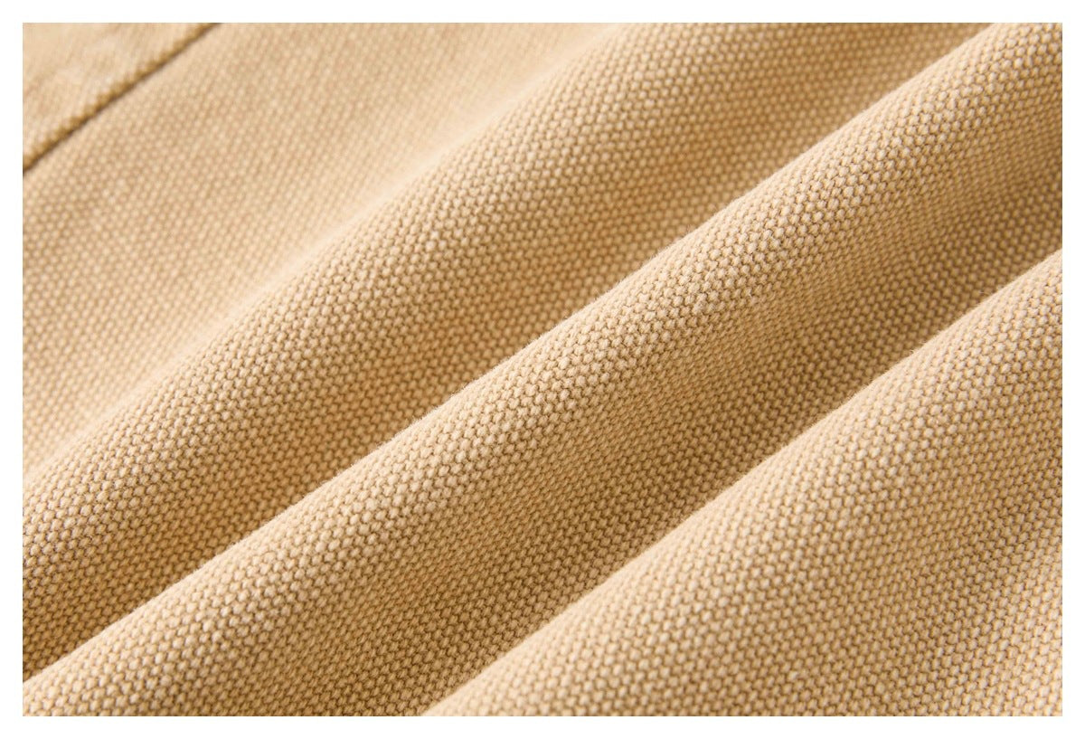 Close-up of the textured tan woven fabric draped in folds.