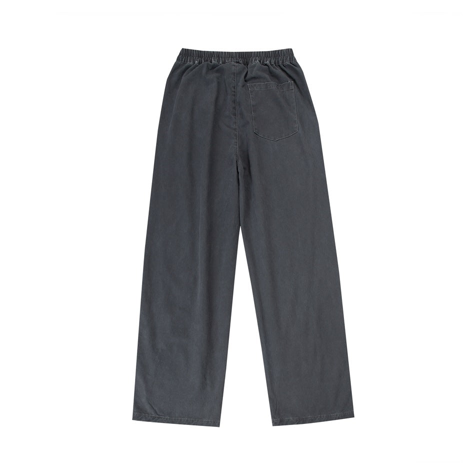 Back view of charcoal wide-leg pants with an elastic waistband and a single back patch pocket.