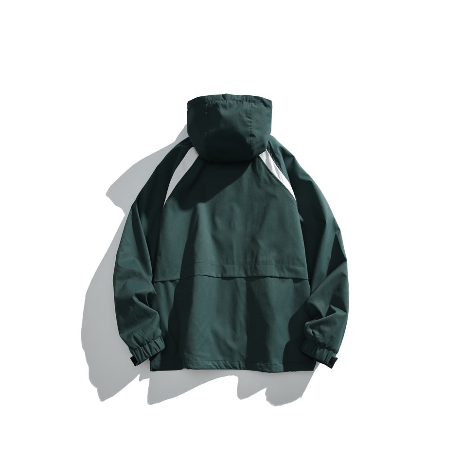 Back view of a dark green hooded pullover jacket with light shoulder accents and elastic cuffs, laid flat.