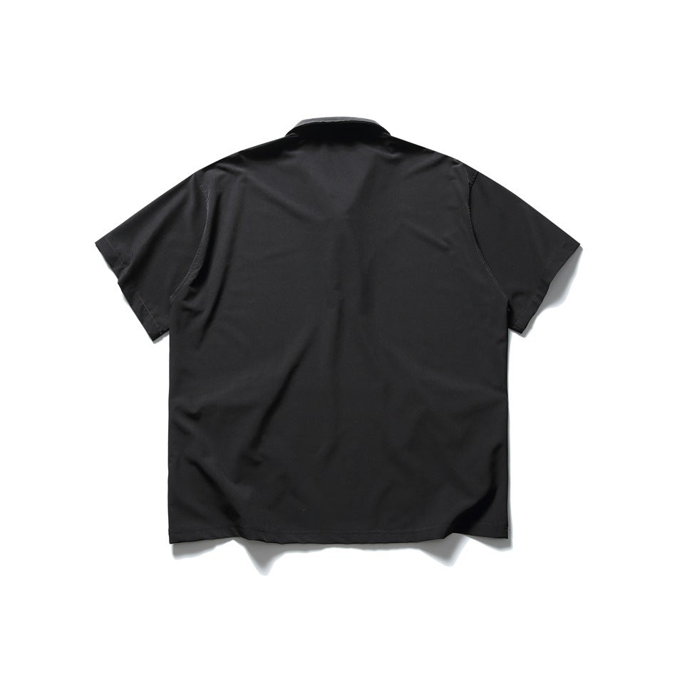 Back view of a black short-sleeve polo shirt laid flat, plain back with no print