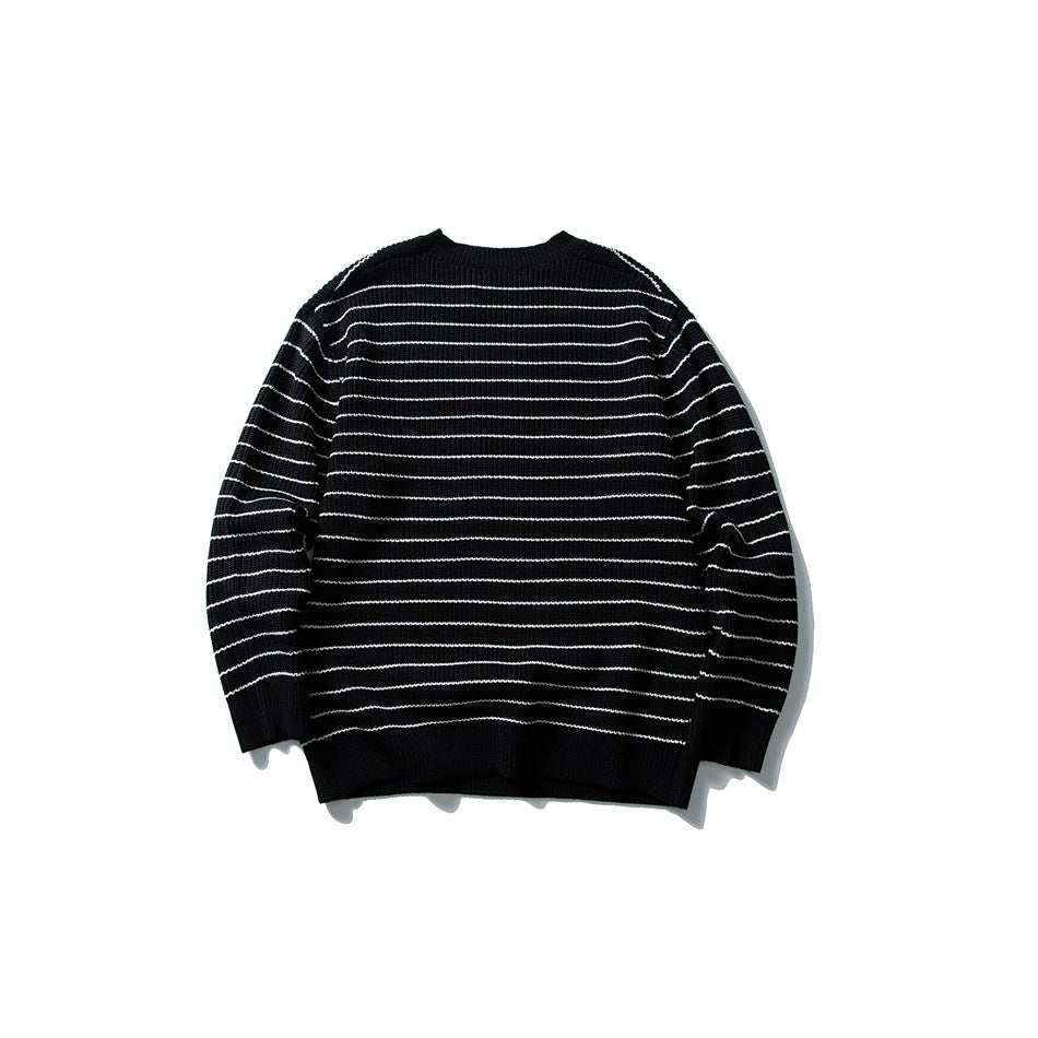 Black rib-knit crewneck sweater with thin white horizontal stripes, shown flat against a white background.