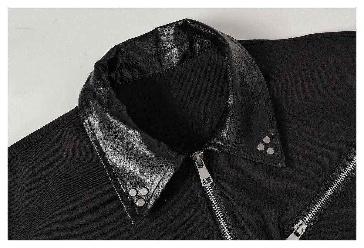Close-up of a black jacket’s leather-look collar, silver snaps, and front zipper details.