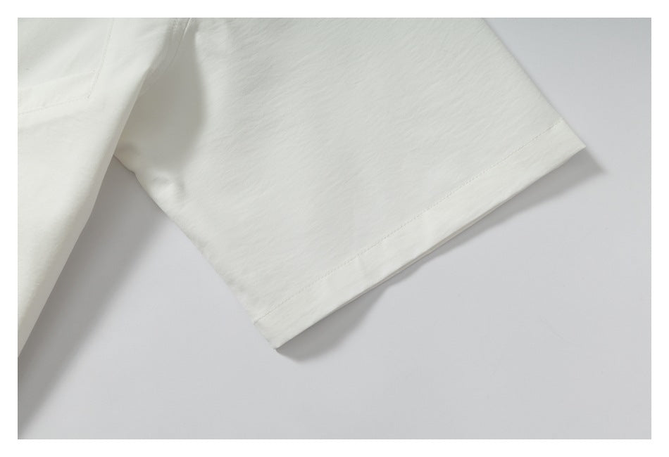 Close-up of an off-white short sleeve and its stitched hem.