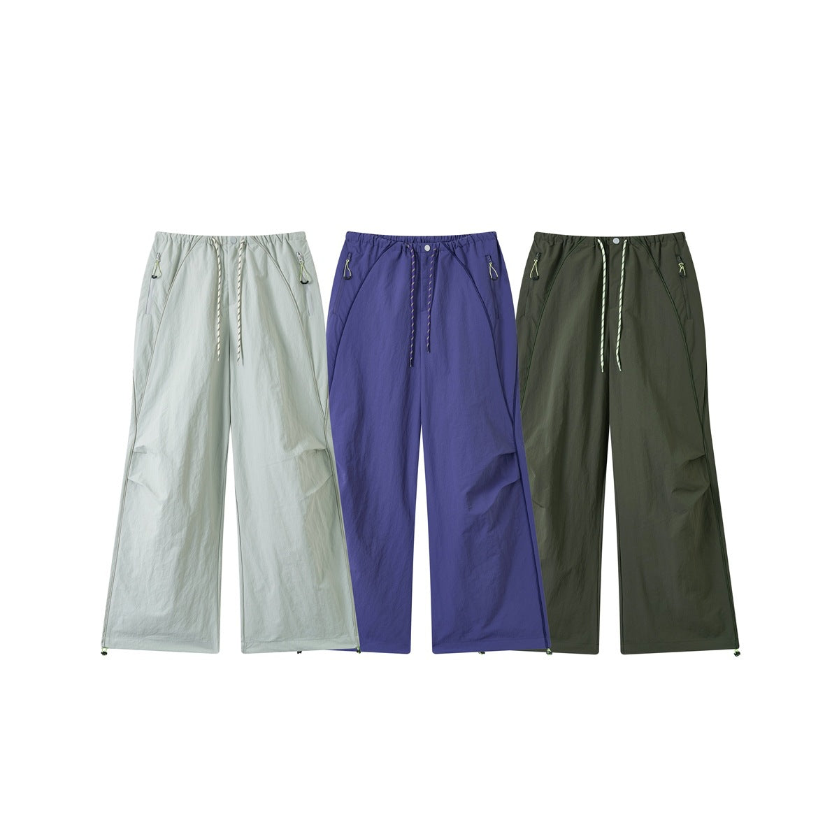 Three front views of wide-leg pants in pale sage, violet, and dark olive, with drawstring waists and zip pockets.