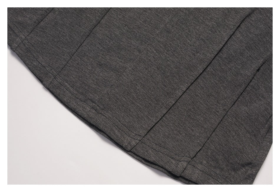Close-up of the charcoal top's lower hem and vertical seam details.