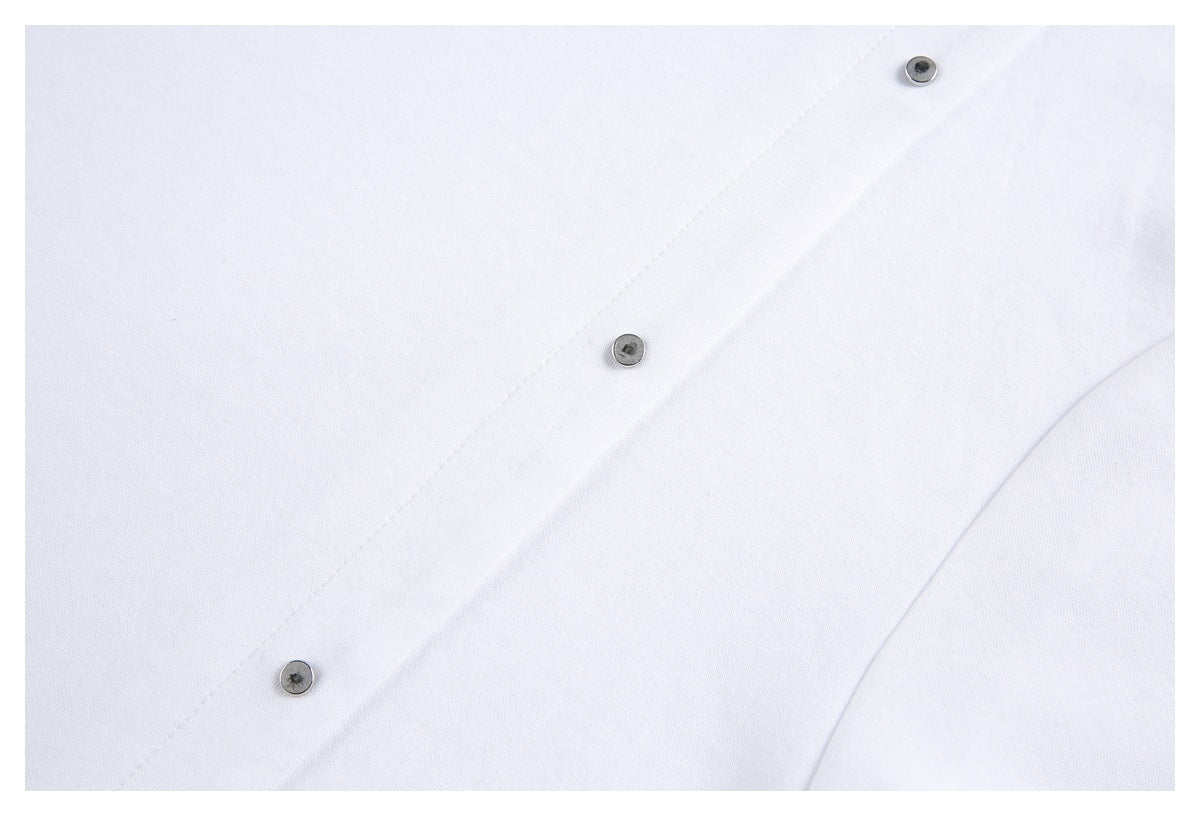Close-up of a white T-shirt with a diagonal seam and three small round metal studs.
