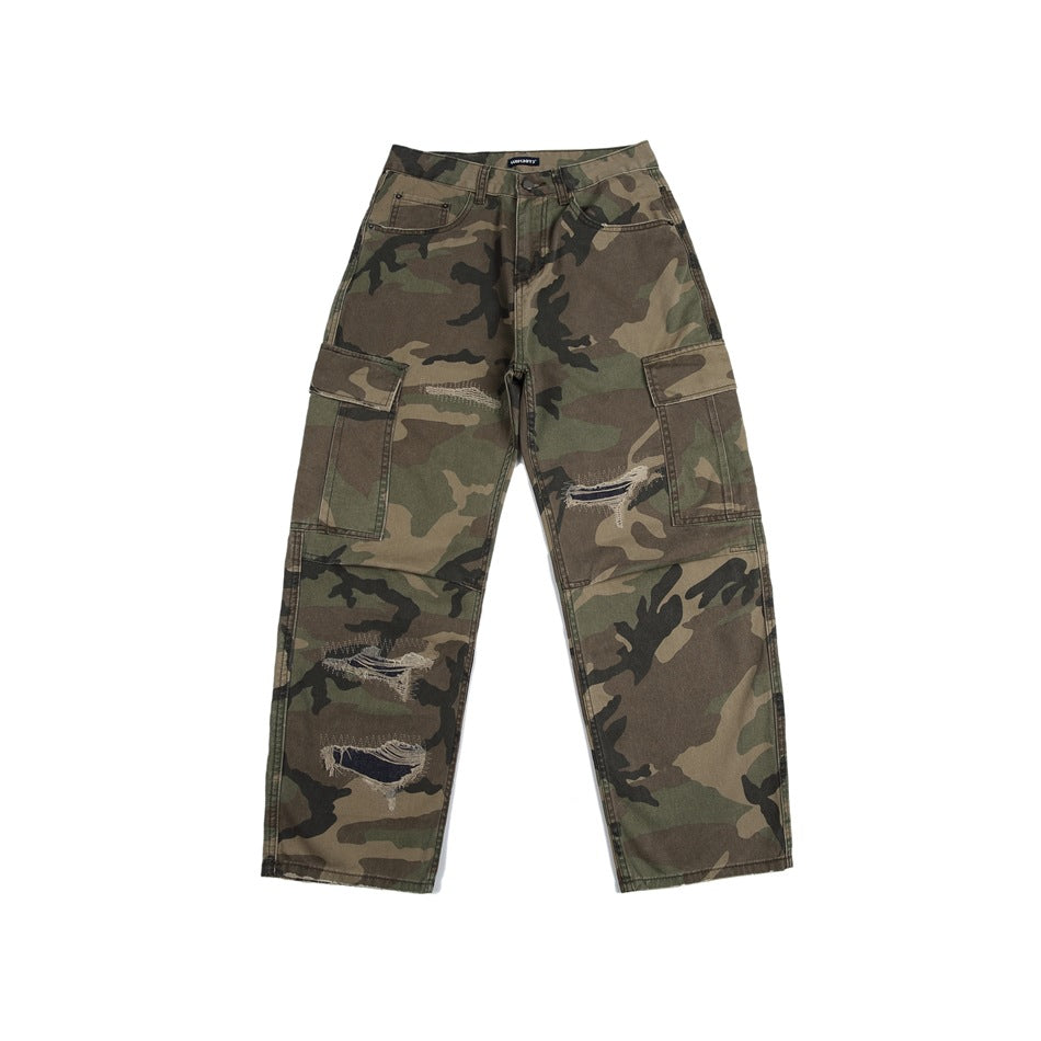 Front flat lay of green camouflage cargo pants with flap thigh pockets and distressed rips on the legs