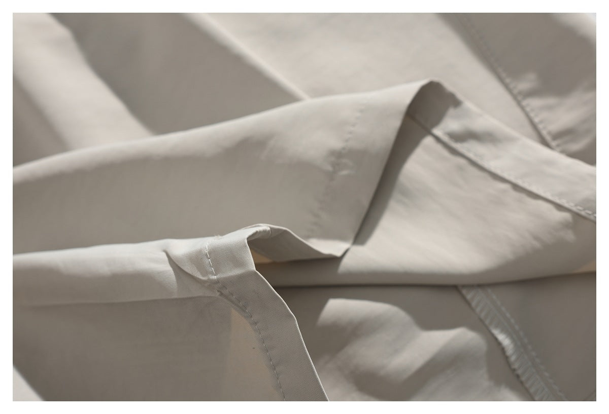 Close-up of a stitched pocket opening and fabric construction on light beige trousers.