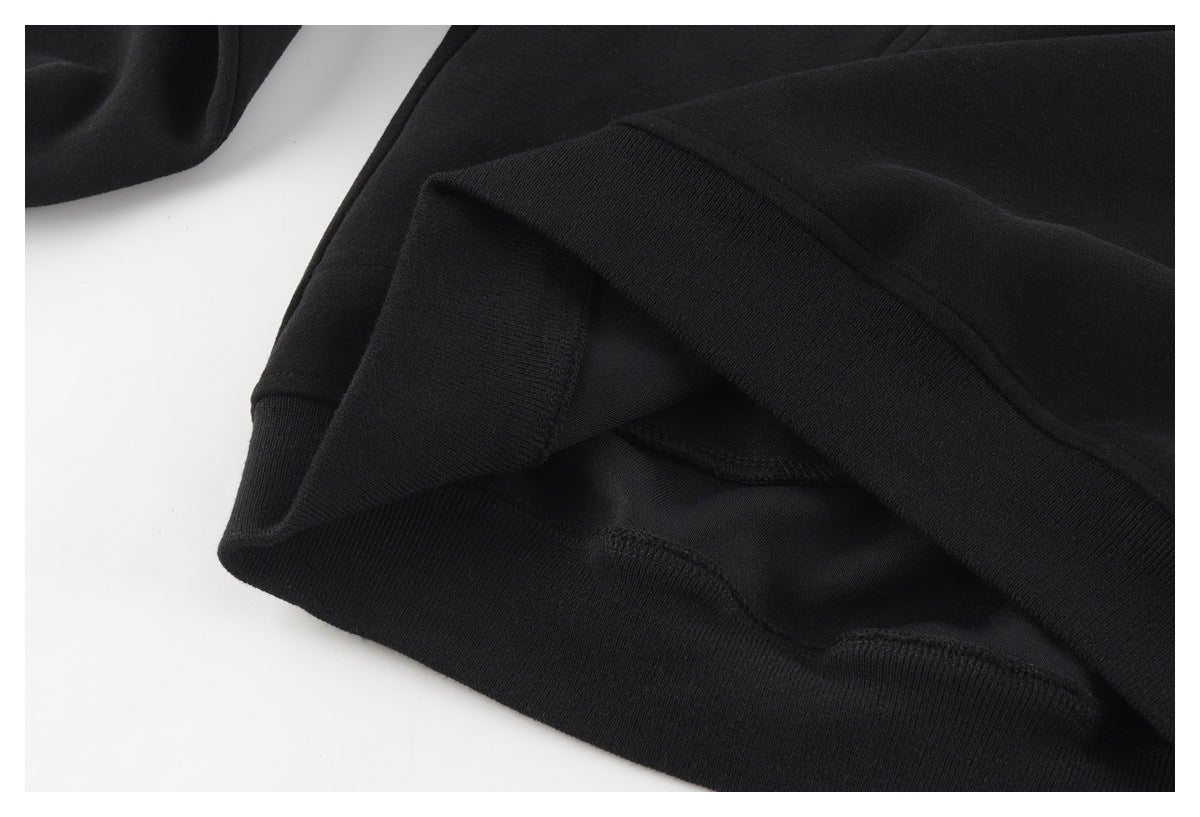 Close-up of a black garment's ribbed hem and interior stitching.