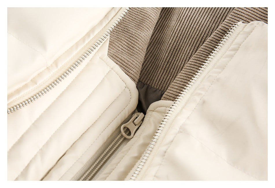 Close-up of cream jacket zippers beside taupe ribbed knit trim.