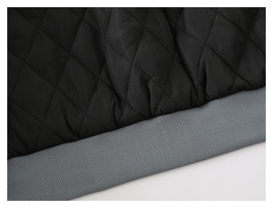 Close-up of black diamond-quilted fabric beside a wide gray ribbed edge.
