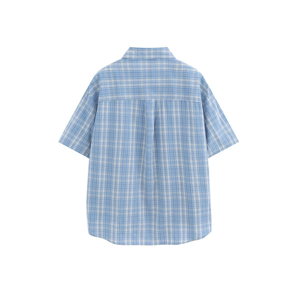 Back view of a light blue and white plaid short-sleeve shirt with a yoke seam and center pleat.