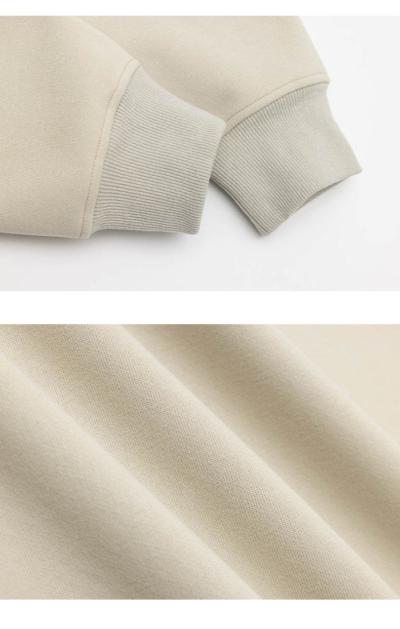 Close-up of a light beige garment sleeve with a ribbed cuff and a view of the knit fabric texture.