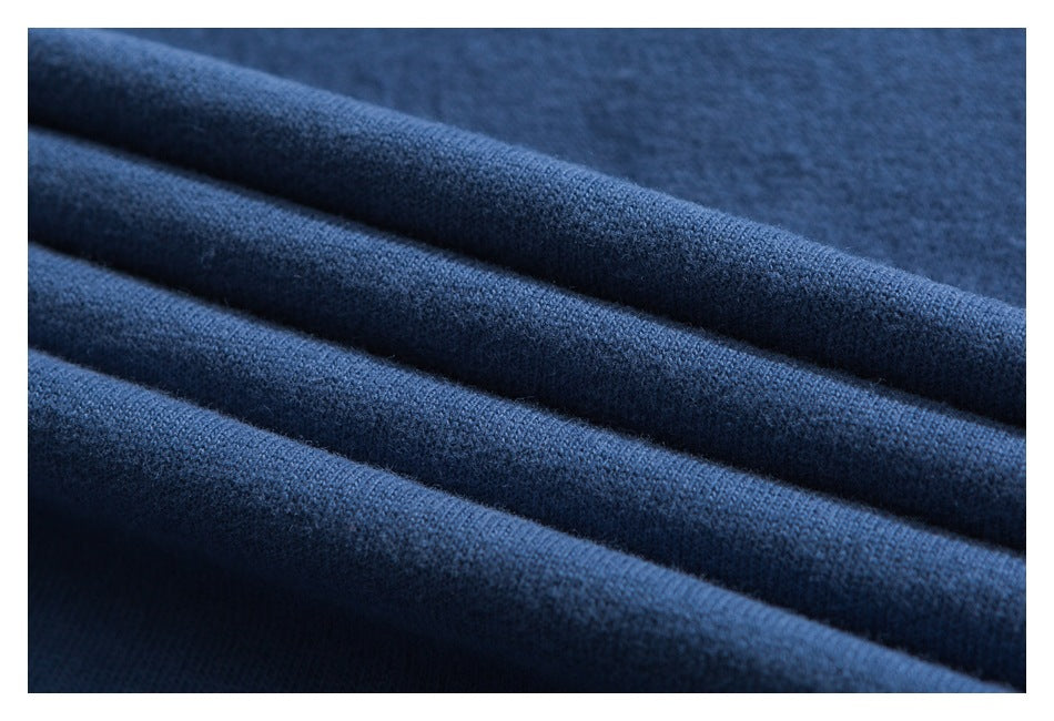 Close-up of dark blue fabric arranged in soft folds, showing its textured surface.