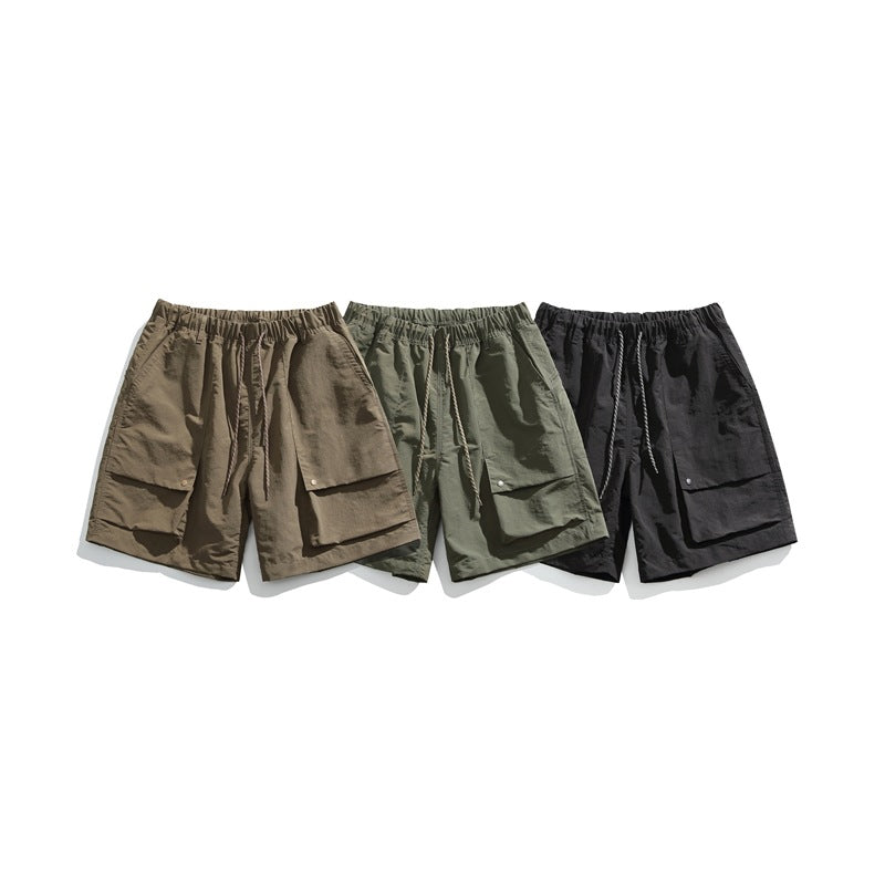 Three pairs of cargo shorts displayed together in brown, muted green, and black.