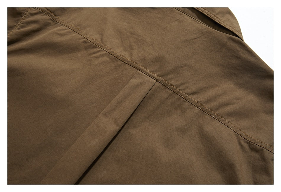Close-up of a brown shirt's back yoke seam and stitched panel construction.