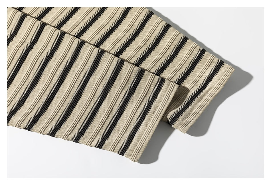 Close-up of the striped shirt's sleeve cuff and matching beige-and-black fabric.