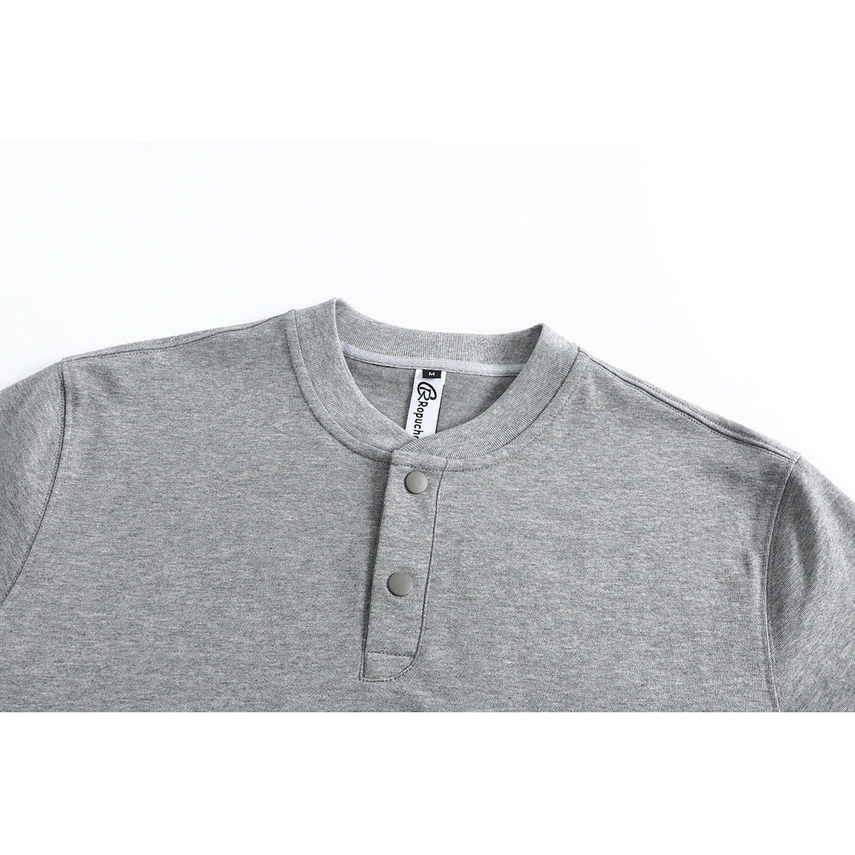 Close-up of a heather gray T-shirt collar and two-button placket, with the inside neck label visible.