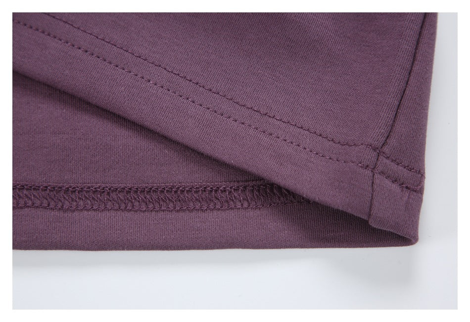 Close-up of the purple garment's stitched hem and folded edge.