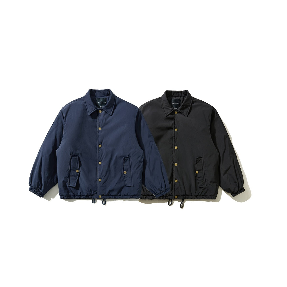Front view of two collared jackets, one navy and one black, with snap closures and front pockets.