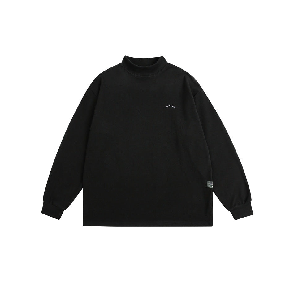 Black mock-neck long-sleeve top flat lay, front view, with small arched chest print and ribbed cuffs