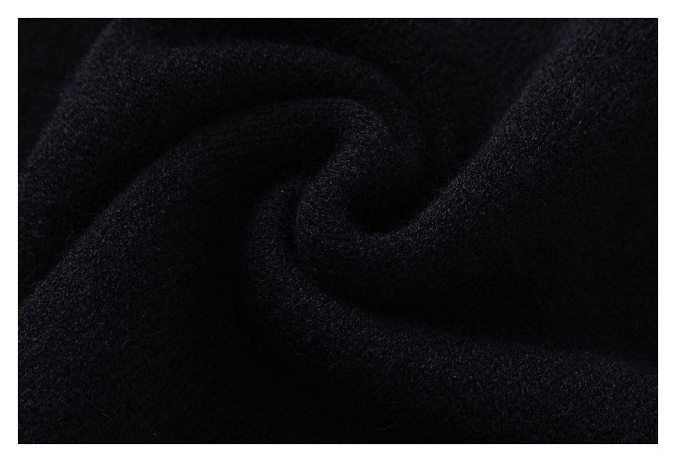 Macro view of the soft-looking black knit fabric gathered into folds.