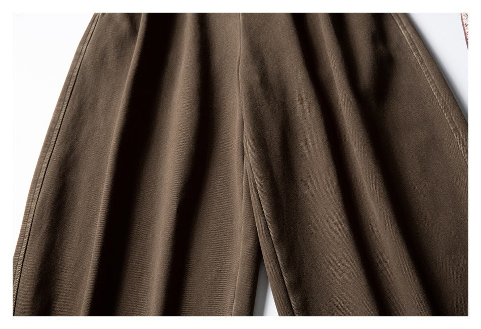 Close-up of the dark brown trouser legs, showing the center seam and fabric texture.