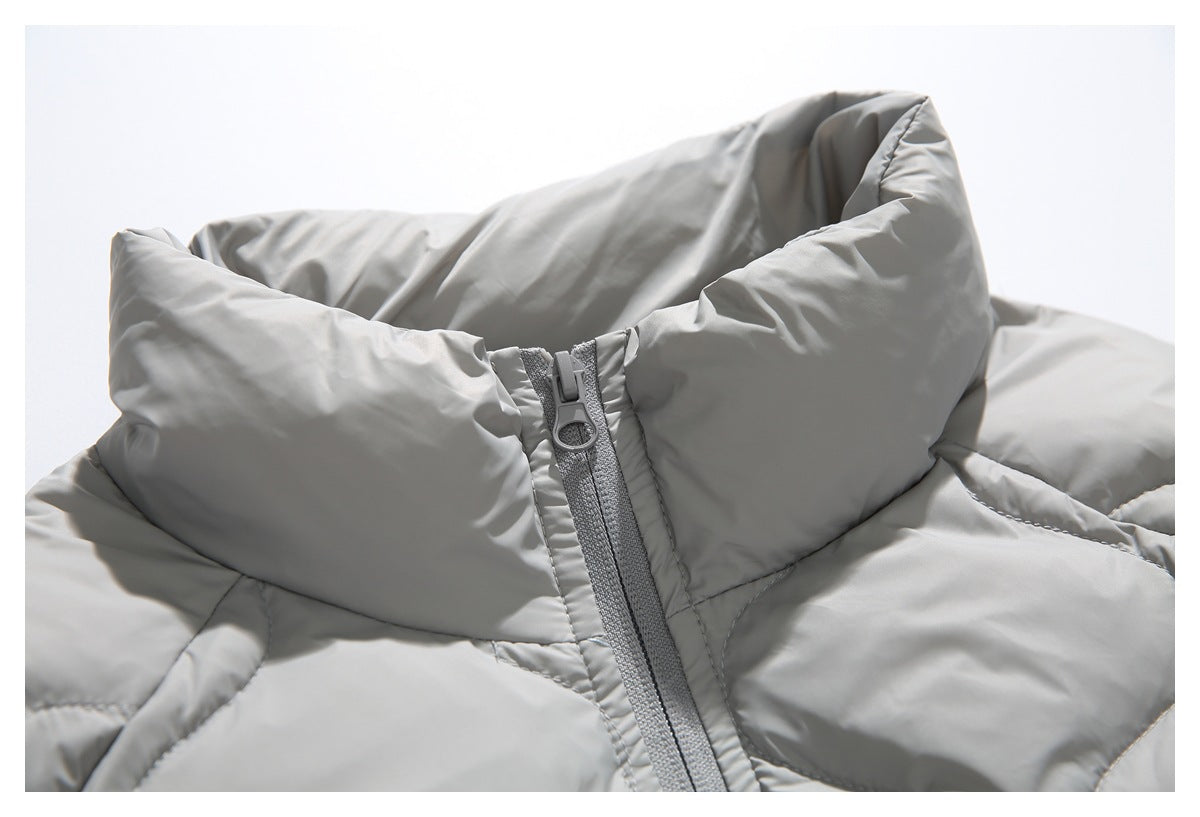 Close-up of a light gray padded jacket collar and central zipper.