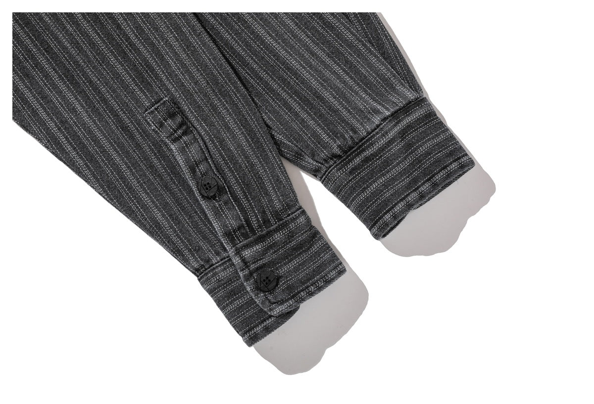 Close-up of the charcoal pinstriped shirt's long sleeves and buttoned cuffs.