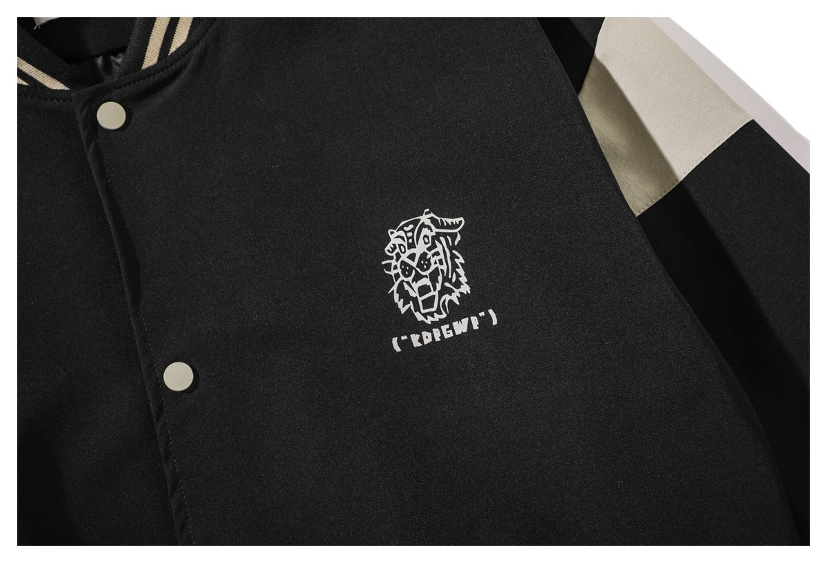 Close-up of the black jacket's white animal-head chest graphic, snap placket and cream sleeve panel.