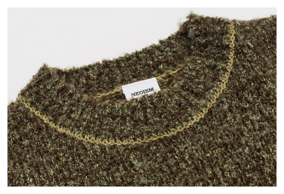 Close-up of an olive-brown marled sweater neckline, contrasting trim, and sewn label.