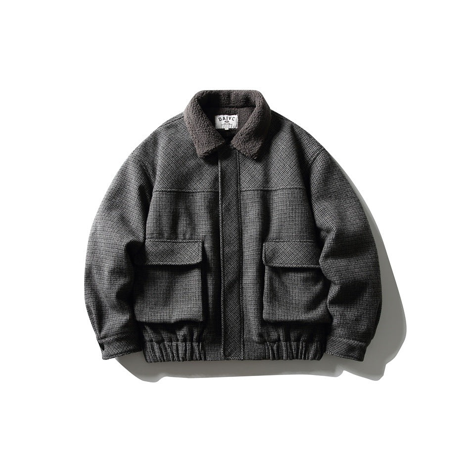 Dark gray houndstooth bomber-style jacket with fleece-like collar, two flap pockets and elastic hem, front view