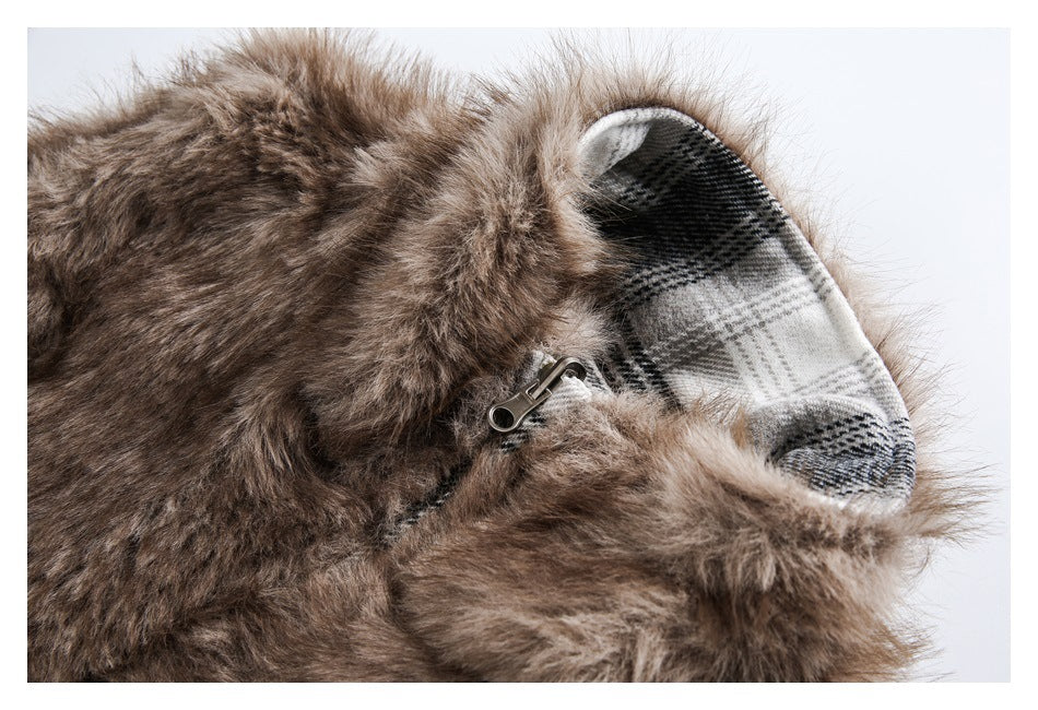 Close-up of brown faux fur, a metal zipper pull and the garment's black-and-gray plaid lining.