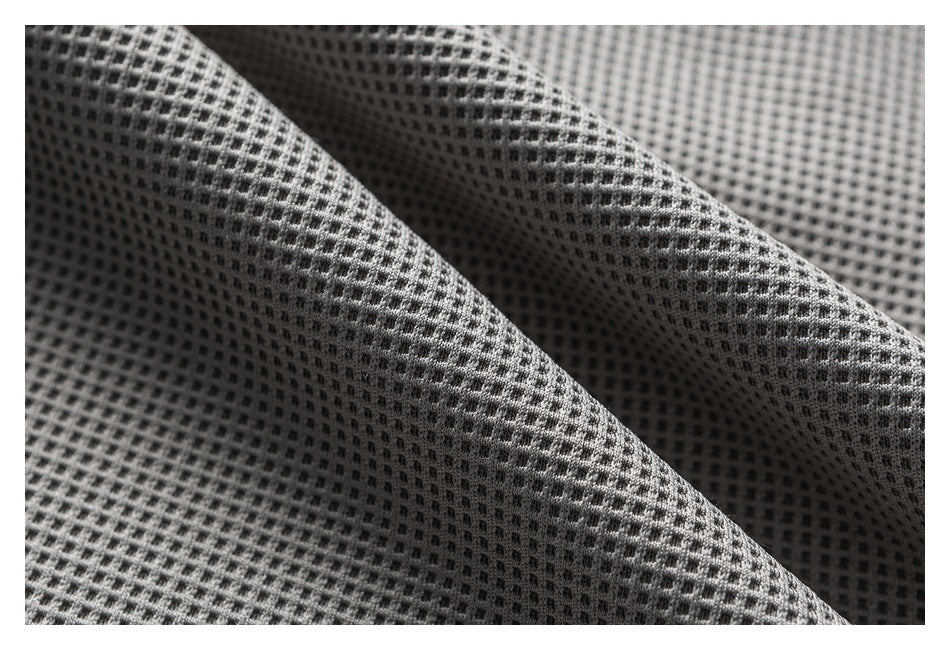 Extreme close-up of the gray shorts' raised waffle-like fabric texture.