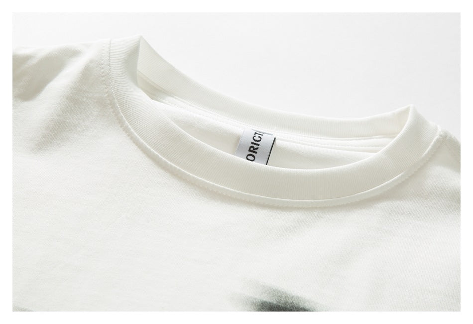 Close-up of an off-white T-shirt's ribbed crew neck and inner label.