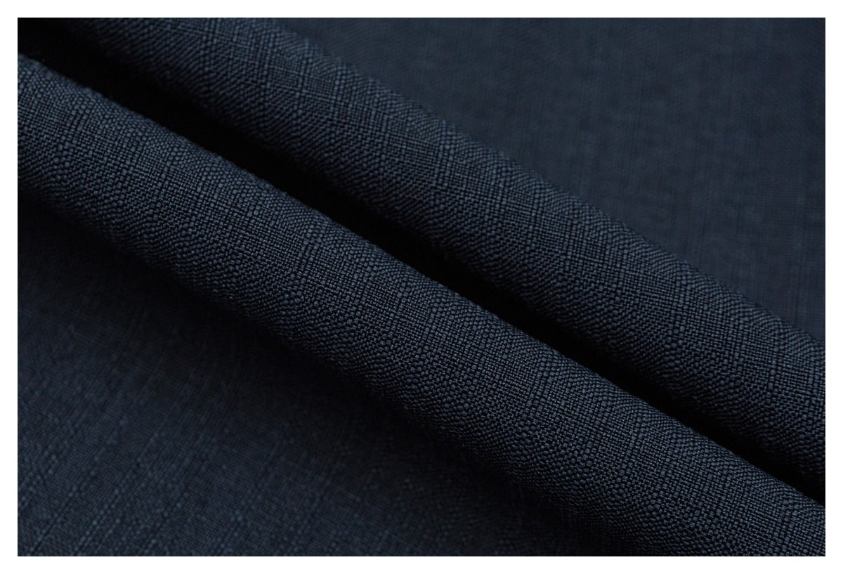 Close-up showing the textured weave of dark navy fabric folded into ridges.